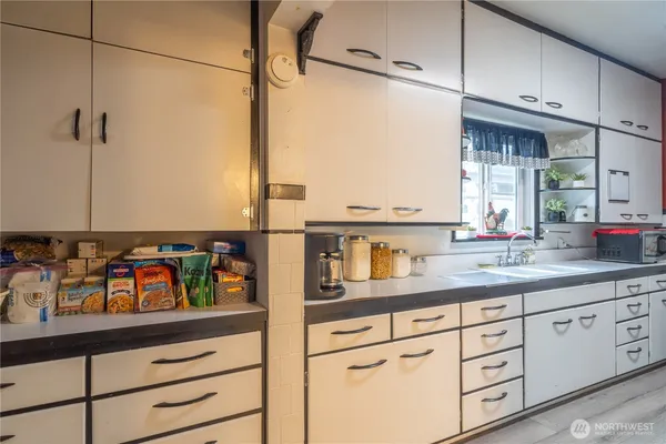 a kitchen with sink cabinets and window