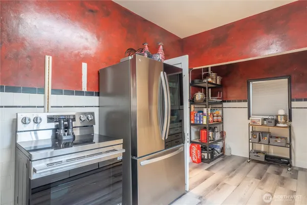 a kitchen with refrigerator and cabinets