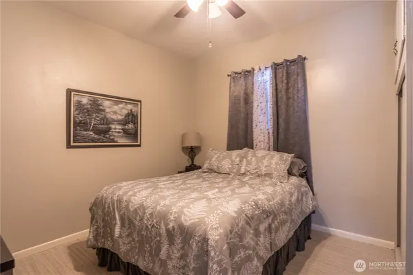 a bedroom with a large bed and a chandelier