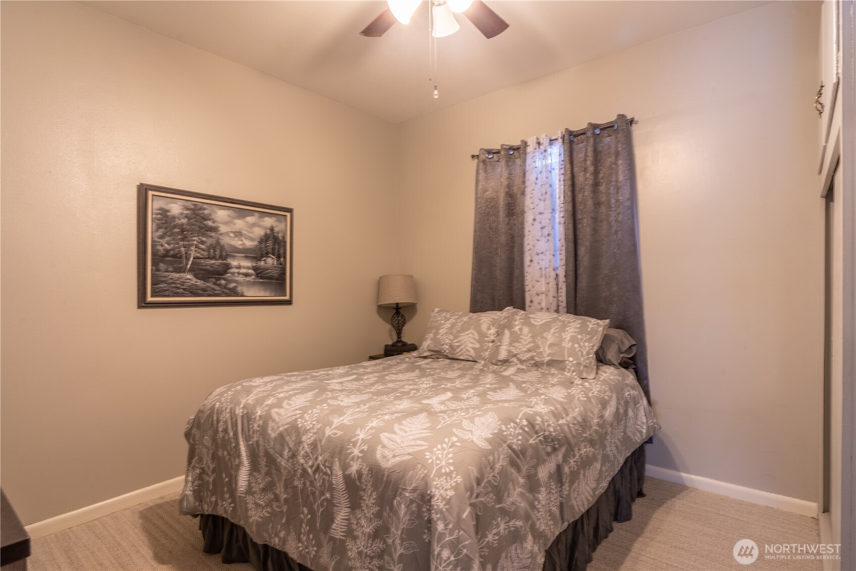 102 West 3rd Street Lind, WA 99341 - Photo 16 of 27 a bedroom with a large bed and a chandelier