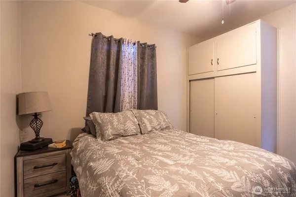 a bedroom with a bed and a window