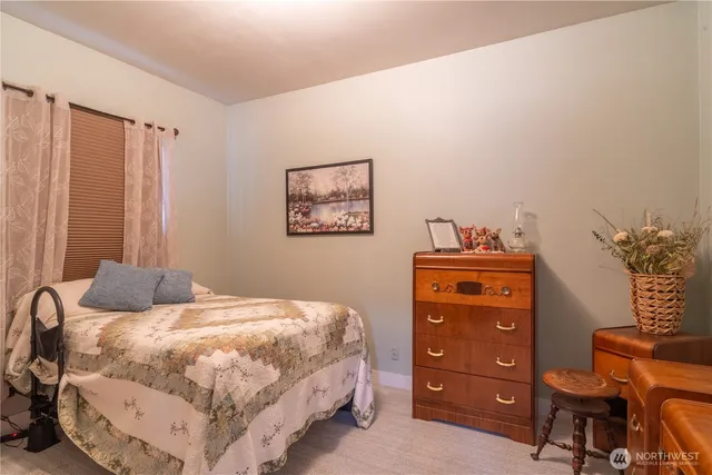 a bedroom with a bed a lamp and a closet