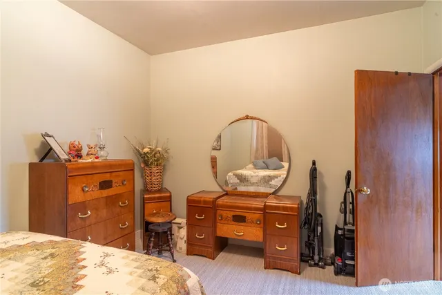 a bedroom with a bed and a dresser