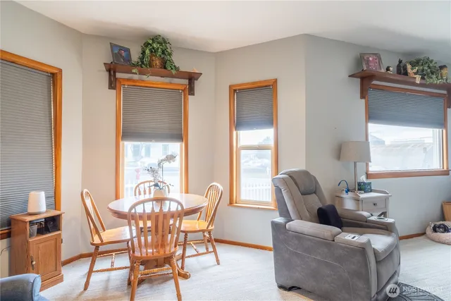 a dining room with furniture and window