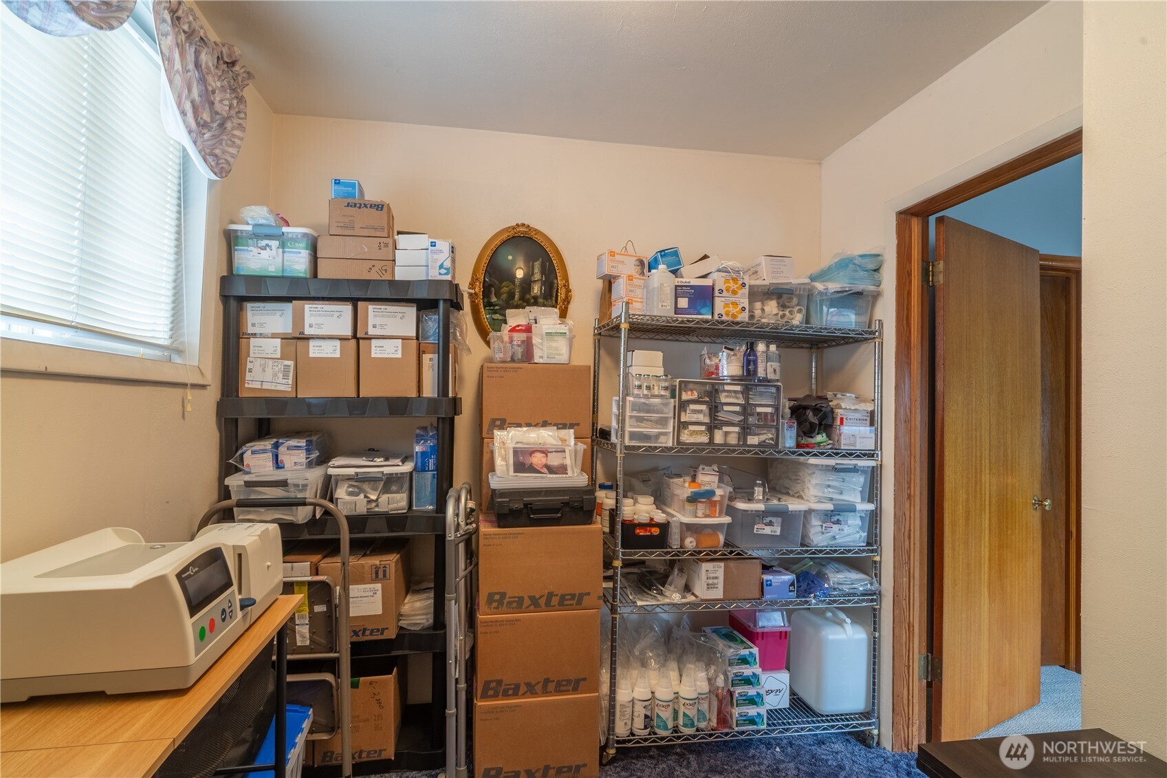 102 West 3rd Street Lind, WA 99341 - Photo 26 of 27 a view of work space with racks on the wall and a window