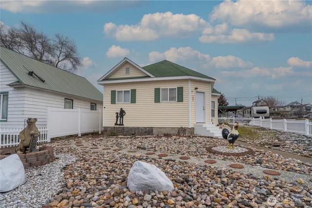 a backyard of a house with barbeque oven table and chairs