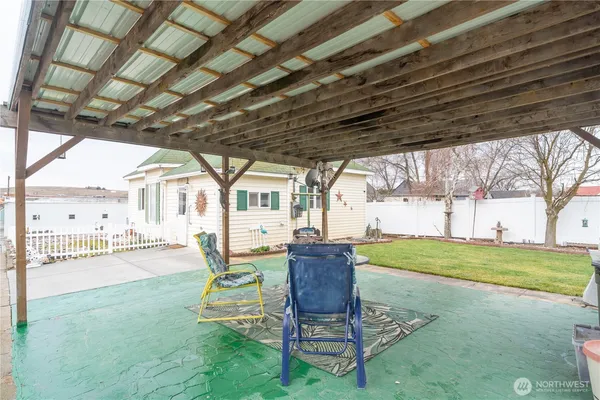 a house view with a garden space and sitting space