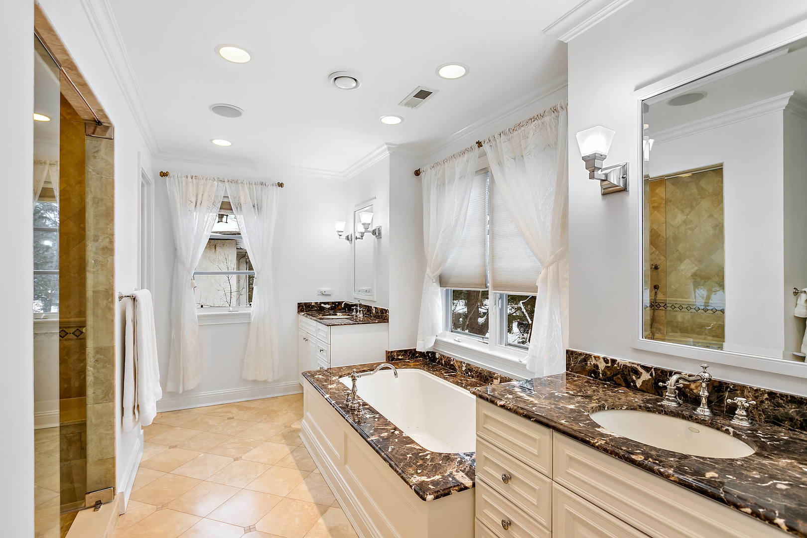 594 Willow Road Winnetka, IL 60093 - Photo 20 of 41 a spacious bathroom with a granite countertop tub sink shower and mirror