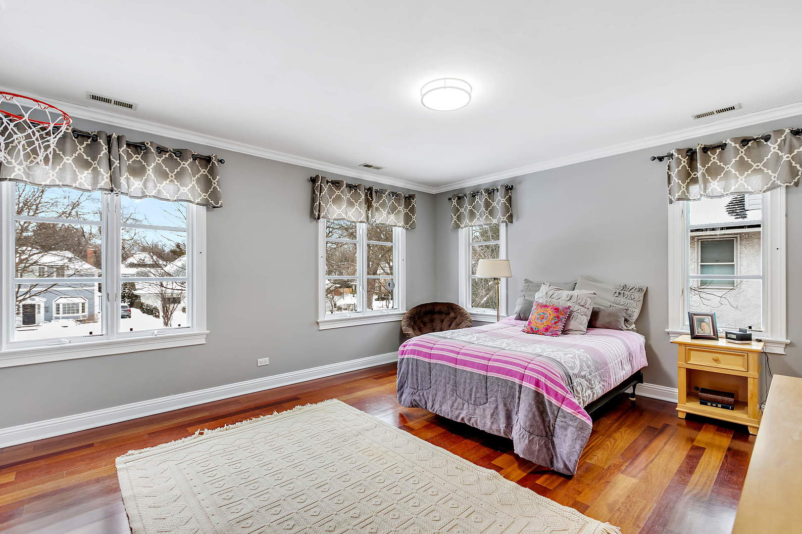 594 Willow Road Winnetka, IL 60093 - Photo 21 of 41 a bedroom with a bed and wooden floor