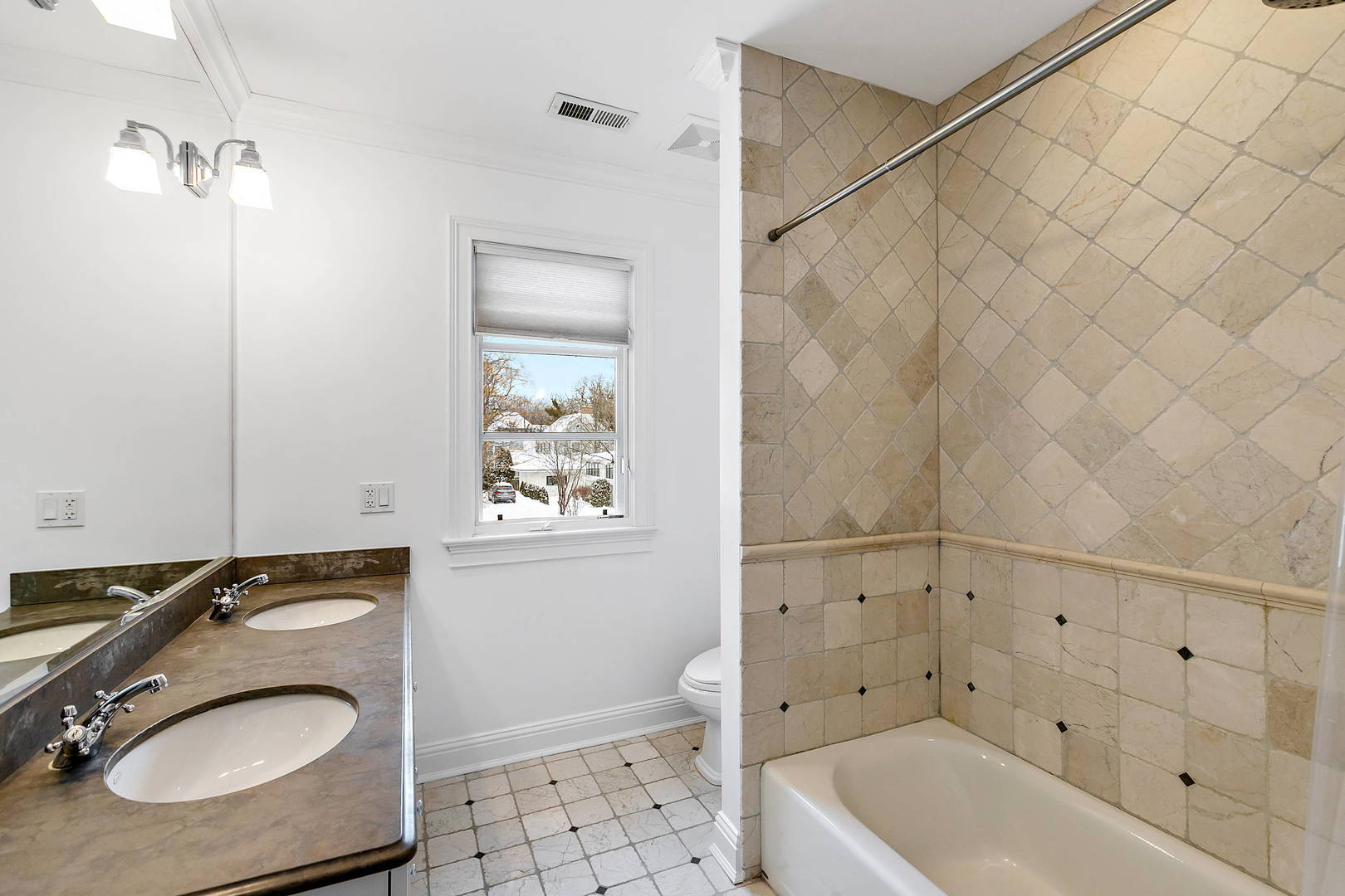 594 Willow Road Winnetka, IL 60093 - Photo 25 of 41 a bathroom with a sink a toilet and shower