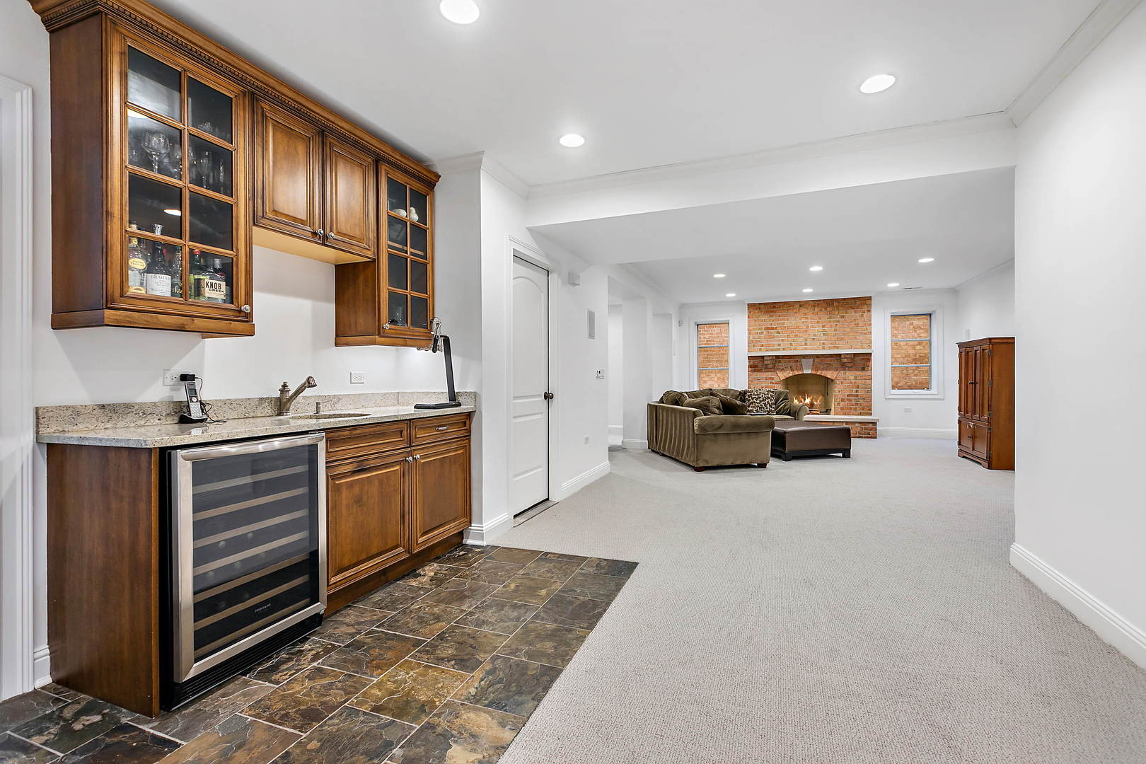 594 Willow Road Winnetka, IL 60093 - Photo 28 of 41 a large white kitchen with a large window and stainless steel appliances