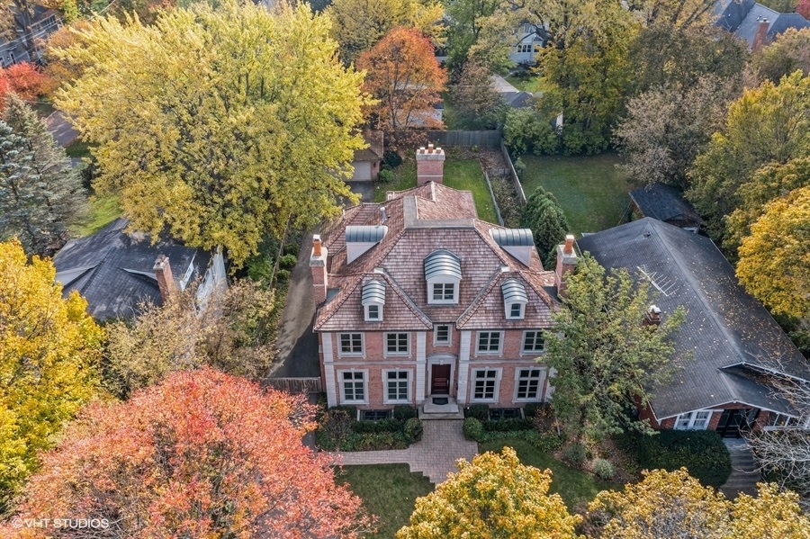 594 Willow Road Winnetka, IL 60093 - Photo 3 of 41 a large building with a lake view and a building in the background