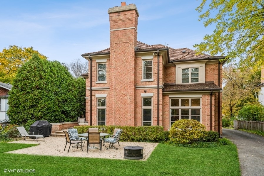 594 Willow Road Winnetka, IL 60093 - Photo 32 of 41 a front view of a house with a yard and trees