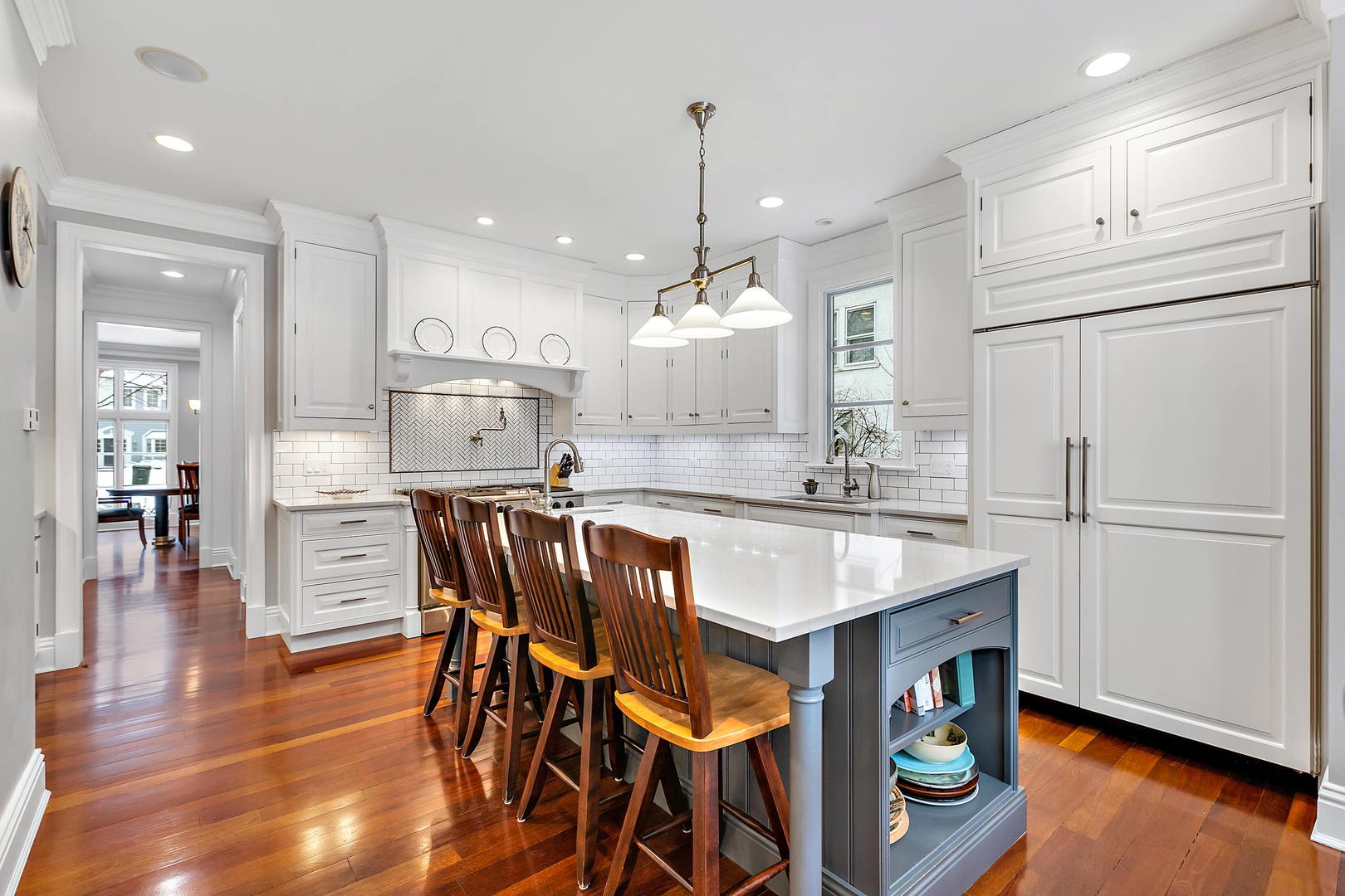594 Willow Road Winnetka, IL 60093 - Photo 10 of 41 a kitchen with stainless steel appliances granite countertop a refrigerator a sink dishwasher a stove and white cabinets with wooden floor
