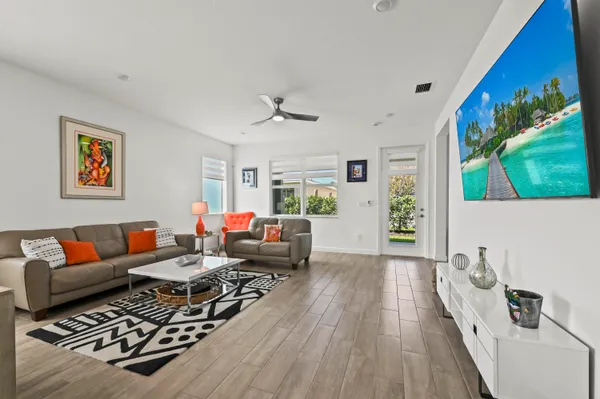 a living room with furniture and a wooden floor