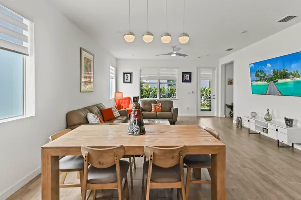 a view of a dining room with furniture and wooden floor