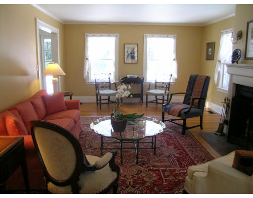 108 Lincoln Road Lincoln, MA 01773 - Photo 3 of 8 a living room with furniture a large window and a fireplace