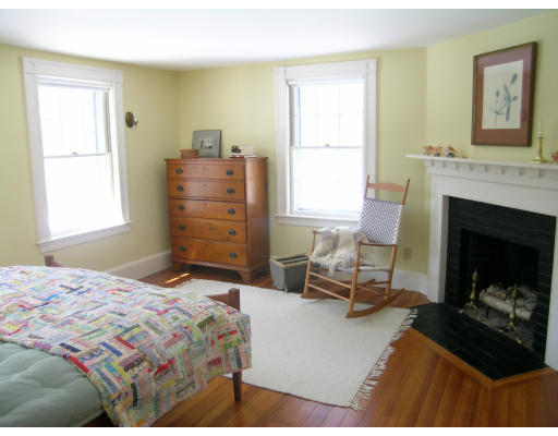 108 Lincoln Road Lincoln, MA 01773 - Photo 7 of 8 a bedroom with a bed and a fireplace