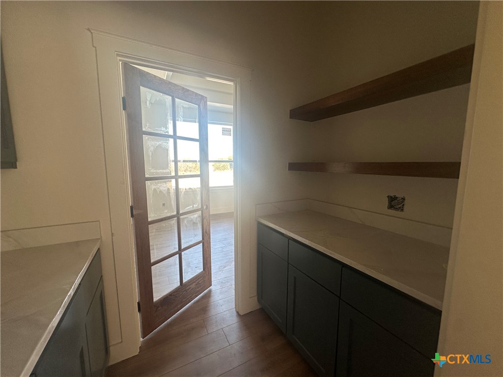 7063 Troyan Lane Temple, TX 76502 - Photo 13 of 28 a kitchen with a white cabinets and a window