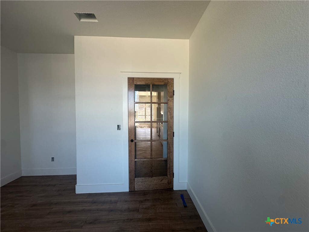 7063 Troyan Lane Temple, TX 76502 - Photo 14 of 28 a view of an empty room with wooden floor