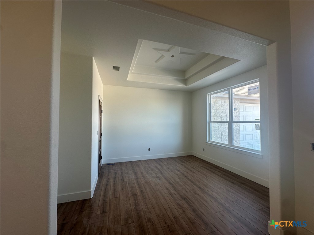 7063 Troyan Lane Temple, TX 76502 - Photo 15 of 28 an empty room with wooden floor and windows