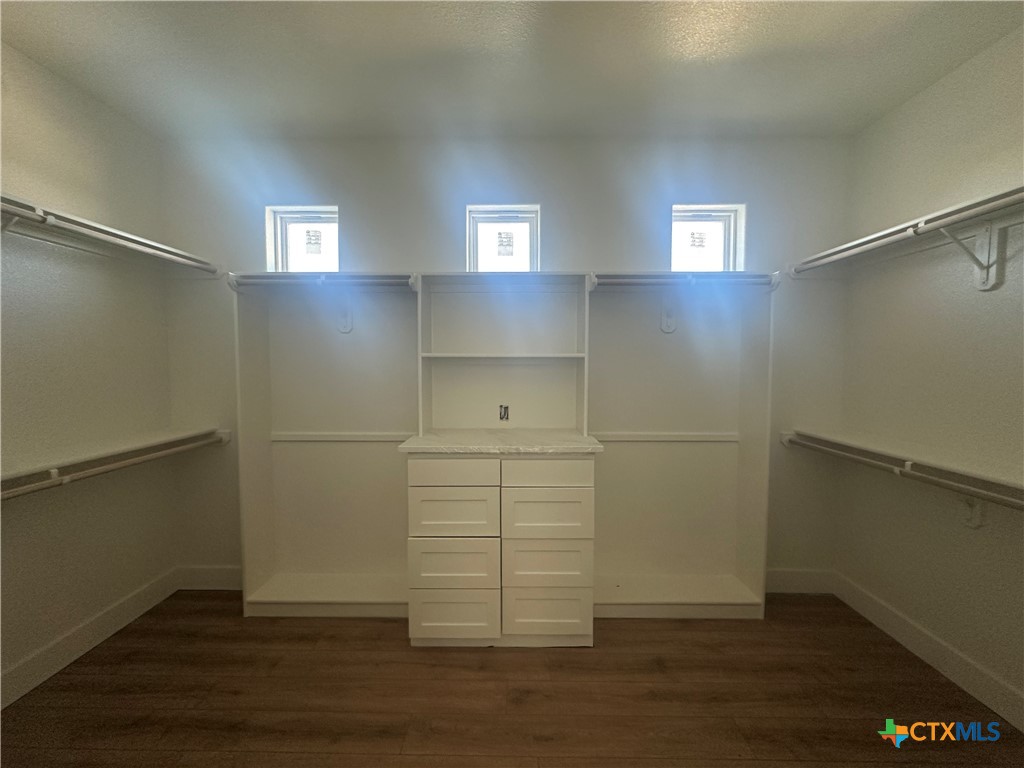 7063 Troyan Lane Temple, TX 76502 - Photo 20 of 28 an empty room with wooden floor cabinet and windows
