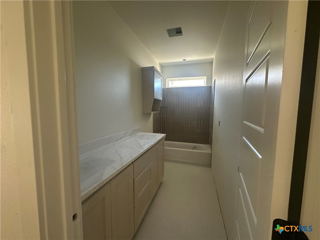 7063 Troyan Lane Temple, TX 76502 - Photo 21 of 28 a bathroom with a granite countertop sink and a mirror