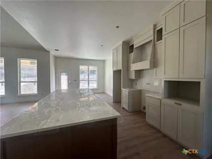 a kitchen with stainless steel appliances a sink stove and cabinets