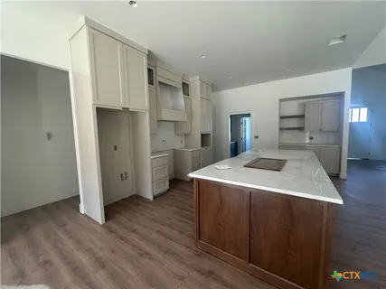 a kitchen with a stove a refrigerator and a sink