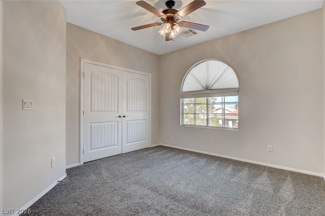 191 Verde Ridge Court Henderson, NV 89012 - Photo 26 of 36 Unfurnished bedroom featuring carpet floors, baseboards, a closet, and a ceiling fan