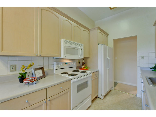 1111 Compass Lane, Unit 204 Foster City, CA 94404 - Photo 3 of 13 a kitchen with stainless steel appliances a stove a refrigerator a sink a counter space and cabinets