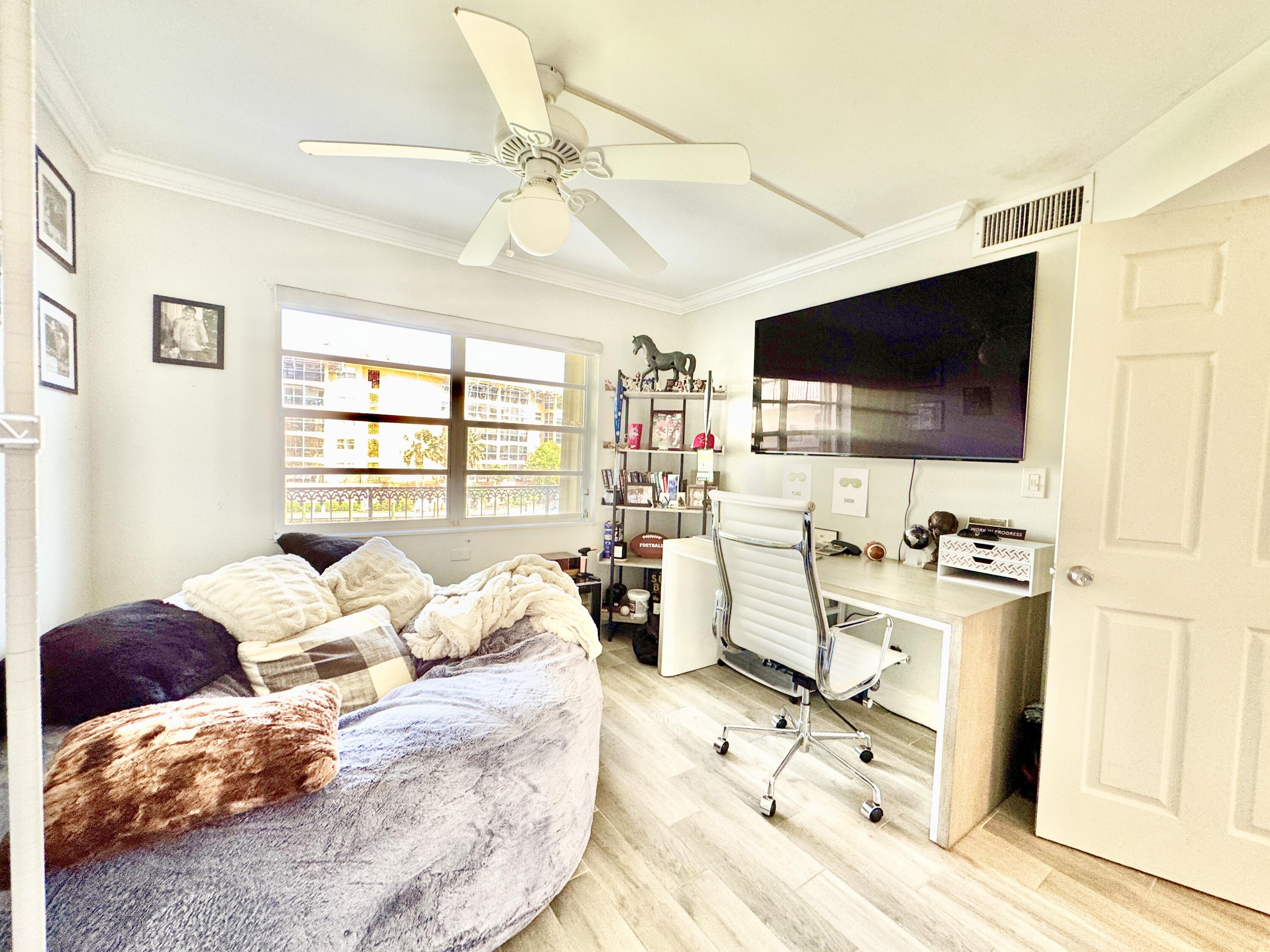 2871 North Ocean Boulevard, Unit R248 Boca Raton, FL 33431 - Photo 14 of 44 a bedroom with furniture and a flat screen tv