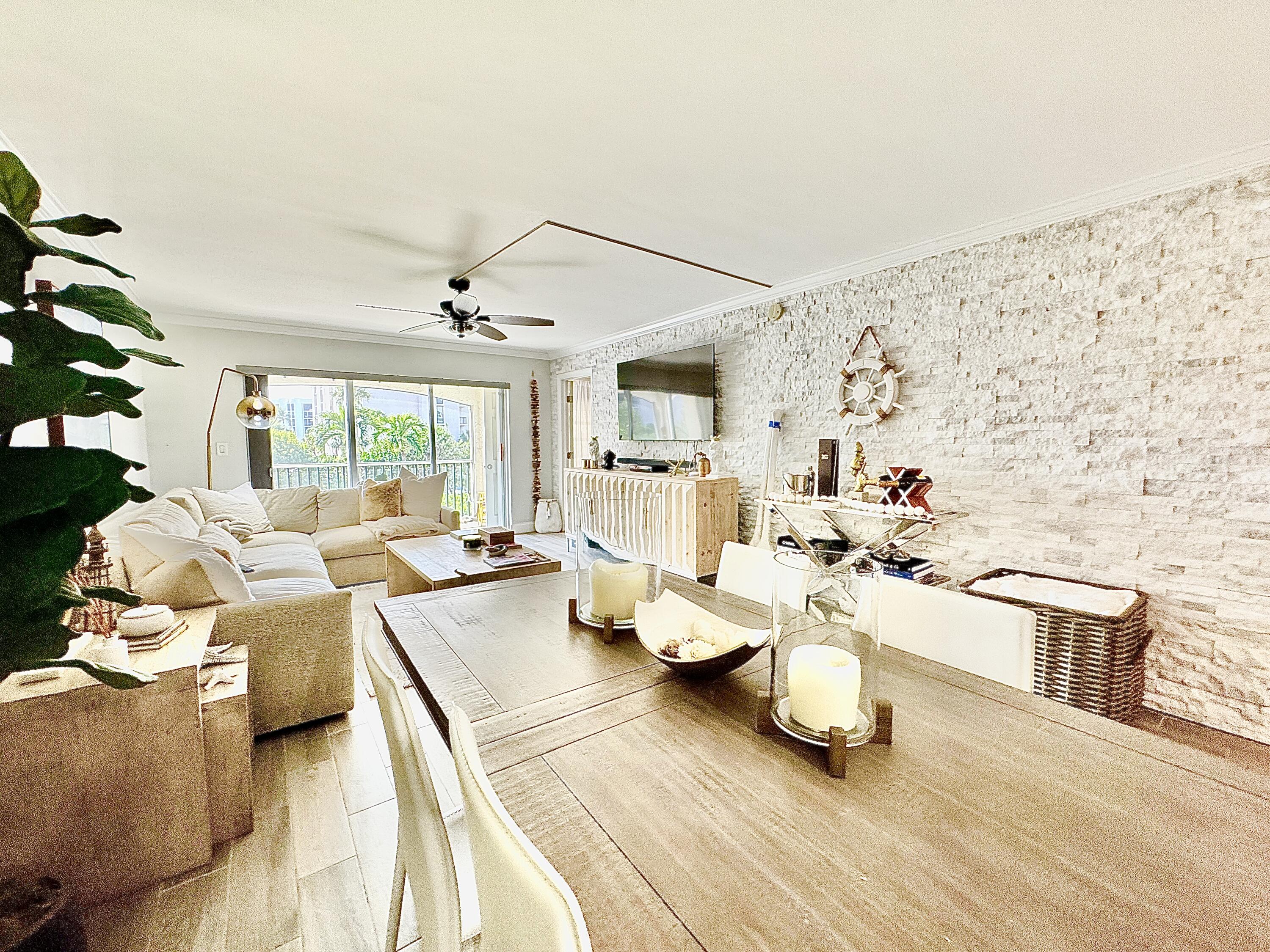 2871 North Ocean Boulevard, Unit R248 Boca Raton, FL 33431 - Photo 2 of 44 a living room with furniture and a flat screen tv