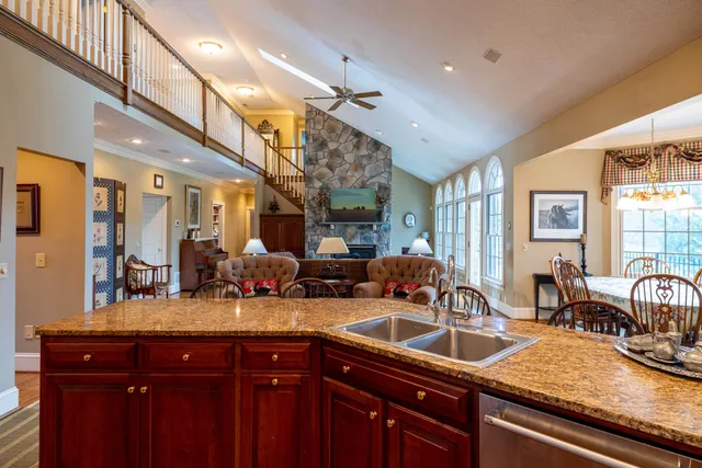a living room with lots of furniture and kitchen view
