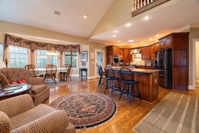 a living room filled with furniture and a large window