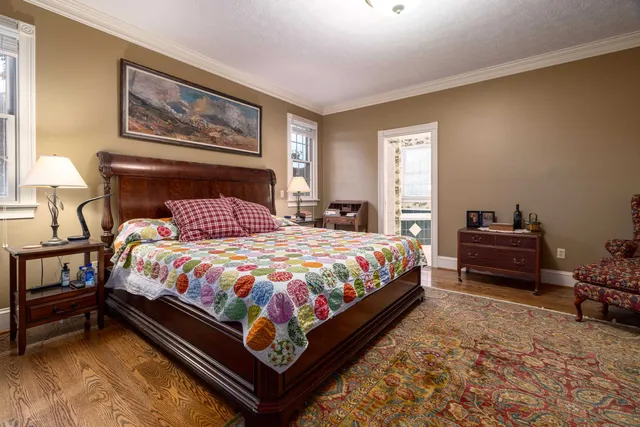a dining room with furniture a chandelier and wooden floor