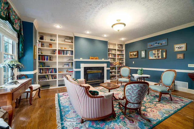 a living room with furniture and a chandelier