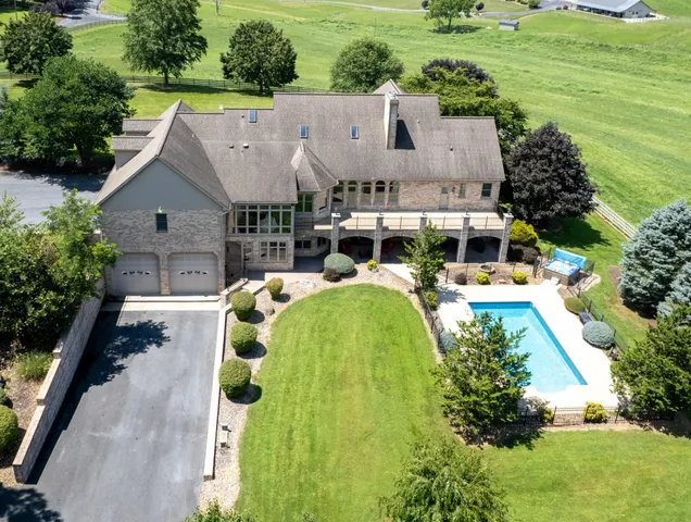 an aerial view of a house with swimming pool garden and outdoor seating