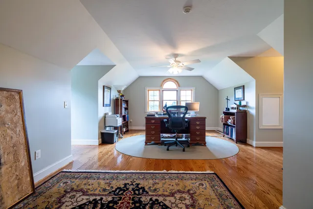 a view of a house with a big yard and potted plants