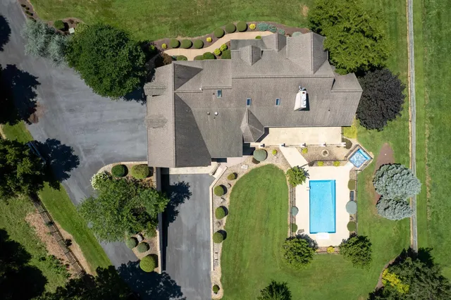 an aerial view of residential houses with outdoor space and swimming pool