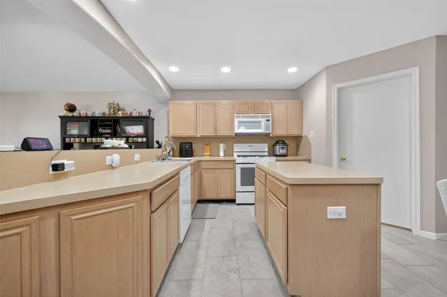 a kitchen with sink and white cabinets