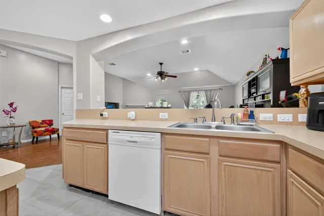 a kitchen with stainless steel appliances granite countertop a sink and a refrigerator