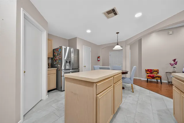a kitchen with white cabinets and chairs