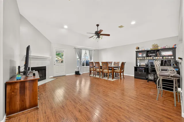 a view of a dining room with furniture and wooden floor
