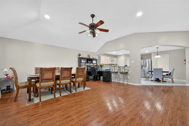 a dining room with furniture and wooden floor