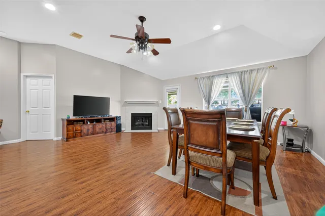 a view of a dining room with furniture and wooden floor