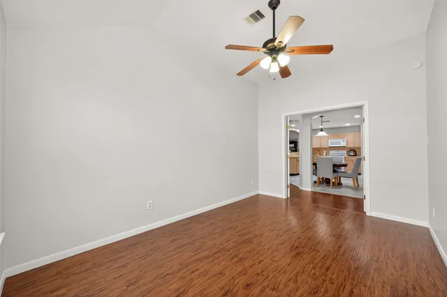 a view of an empty room with wooden floor