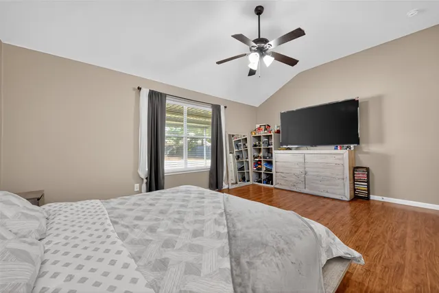 a bedroom with a bed and wooden floor
