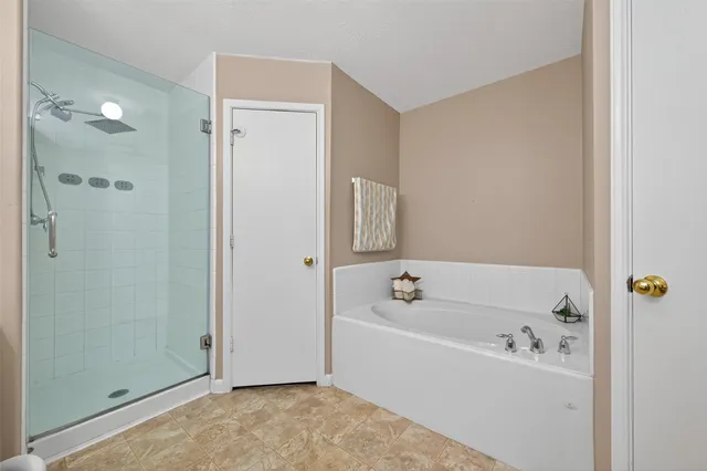 a white bath tub sitting next to a white sink