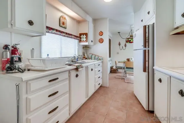 a kitchen with a sink stove and refrigerator